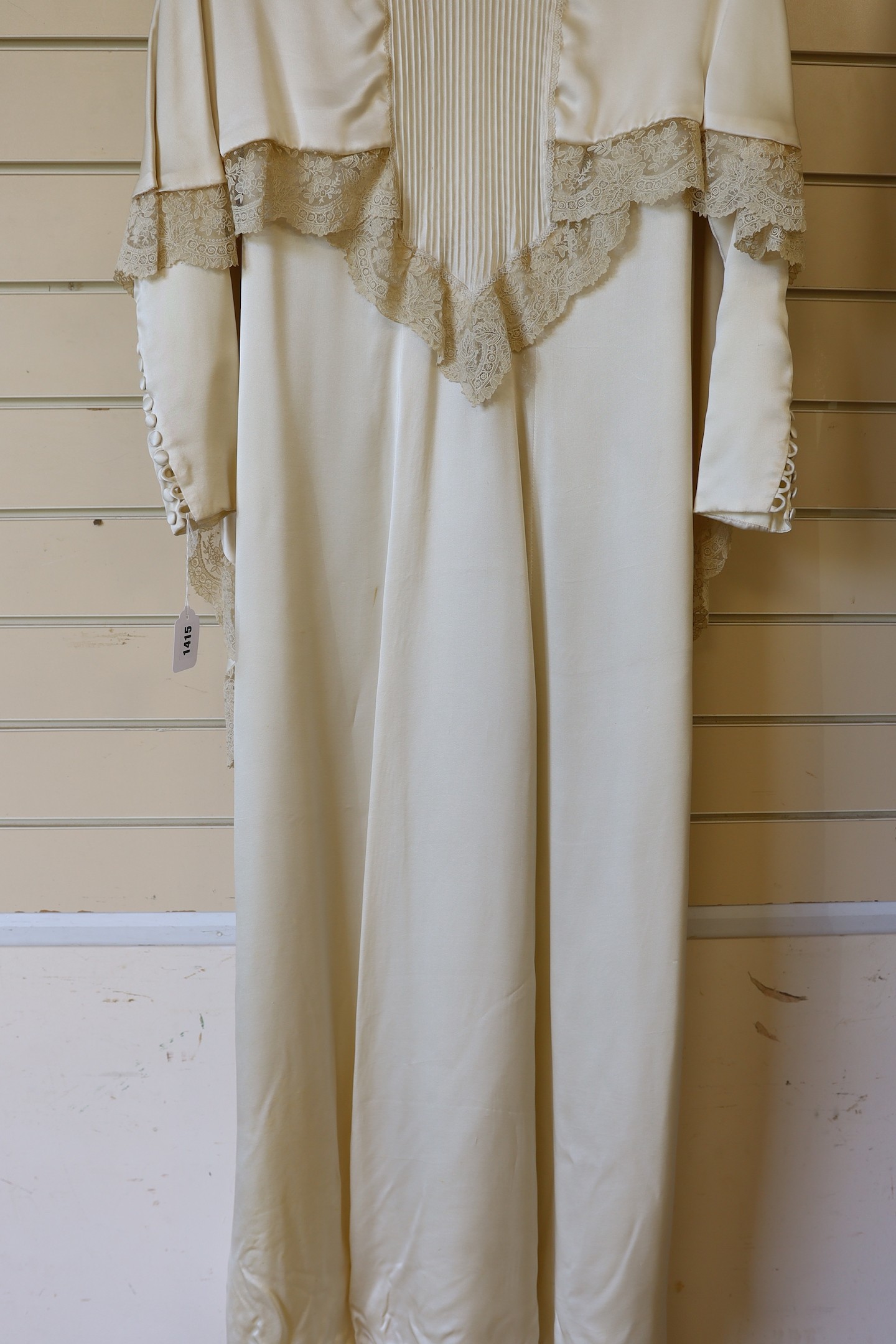 A 1970's cream satin wedding dress, trimmed with 19th century point de gaze, hand made needlepoint lace